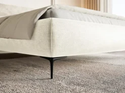 Łóżko tapicerowane 140x200 cm Roule z pojemnikiem stelaż metalowy kremowe szenil nóżki czarne